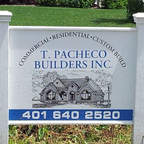 T. Pacheco Builders sign with phone number and image of large house