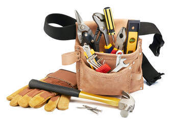 Handyman's toolbelt filled with tools including a hammer, screw driver and worker gloves.